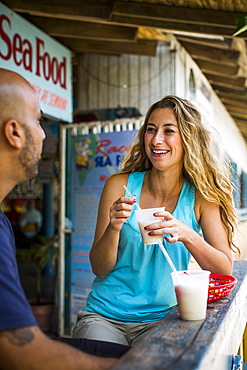 A Woman Enjoying A Pina Colada At Bar In Puerto Rico