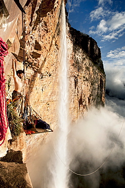 Sean Villanueva at the portaledge camp. Streching at sunrise - Venezuela expedition "jungle jamming" to Amuri tepuy and Tuyuren waterfalls, with Nicolas Favresse, Sean Villanueva, Stephane Hanssens and Jean louis Wertz. The team free climb to new climbingroutes on the Tepuy, which is 3 days of walk to the village of Yunek near Santa helena and the salto angel(canaima).