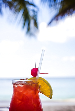 A fruit-laden beverage sweats in the warm tropical air