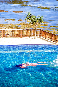 Young woman swimming in pool