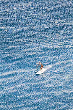 SUP girl enjoying in a beautiful sea