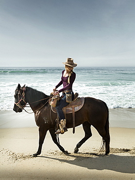 Horserider stroll a beach in Imperial Beach, California near the Mexican border.