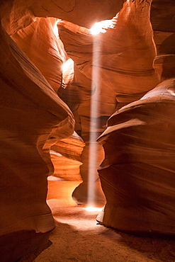 Light beam shines into the orange sandstone of Antelope Canyon in Page, Arizona