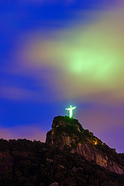 Illuminated Christ the Redeemer statue on top of Corcovado Mountain at night, Rio de Janeiro, Brazil