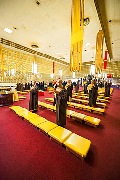 Monks praying in The Jeweled Hall of 10, 000 Buddhas, Ukiah, California, USA