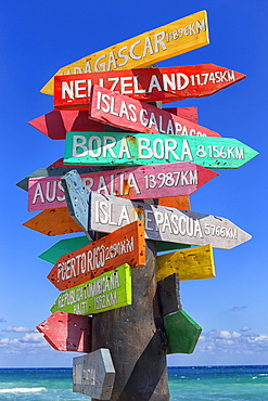 Colorful directional sign with lots of directions, Punta Celarain, Punta Sur Ecological Reserve, Cozumel, Yucatan Peninsula, Mexico