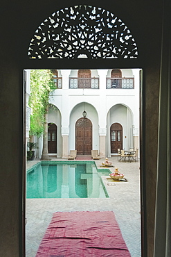 Empty swimming pool in courtyard of Moroccan riad, Marrakech, Morocco