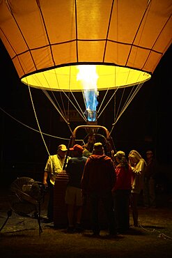 A crew steadies a newly inflated balloon in the morning darkness at the Sonoma County Hot Air Balloon Classic.