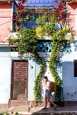 Side view of female tourist walking on street in Trinidad, Sancti Spiritus Province, Cuba