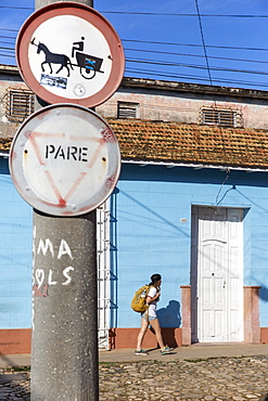 Side view of female tourist walking on street in Trinidad, Sancti Spiritus Province, Cuba