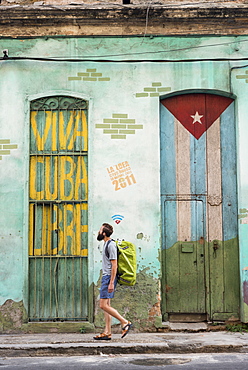 Side view of male tourist walking on street of Havana, Cuba