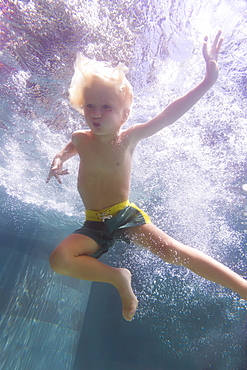 Underwater view of boy swimming in pool