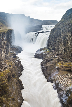 Scenic view of Gulfossi waterfalls flowing through surrounding canyon, Iceland