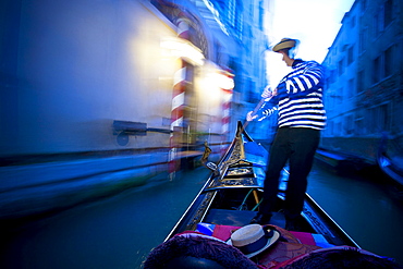 A Gondolier Rowing A Gondola; Venice Venezia Italy