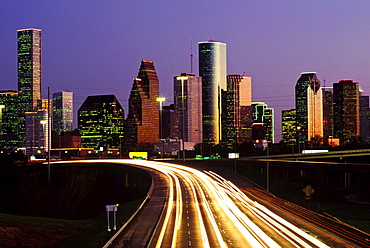 Streaking Car Lights At Night And Downtown Houston In Usa