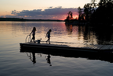 Lake Of The Woods, Ontario, Canada, Two Girls On A Dock