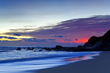 Sunset Over Water And A Beach