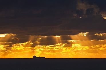 Cargo Ship, Atlantic Ocean, Ship Silhouetted In The Distance In The Ocean