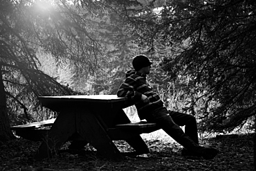 Man Resting On Picnic Table