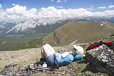 Woman Hiker Resting On A Mountain Top