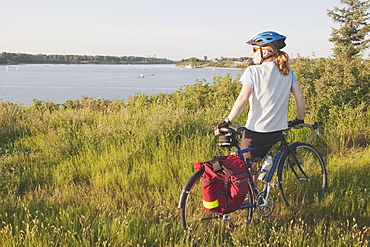 Woman With Bike Along A Lake