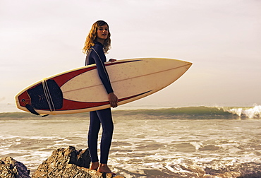 Young Woman With Her Surfboard At The Beach, Tarifa, Cadiz, Andalusia, Spain