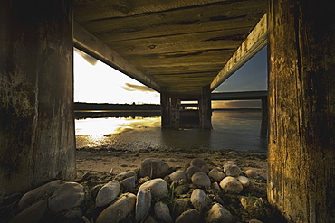 Alberta, Canada, Underneath A Pier Going Out Into The Lake