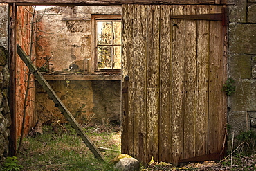 Northumberland, England, An Abandoned Building In Ruins With A Broken Wooden Door