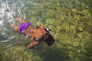 Roatan, Bay Islands, Honduras, A Young Woman Snorkeling At Anthony's Key Resort