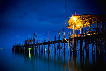 Lights On A Wooden Pier Leading Out In The Water At Night, Kho Samet, Thailand