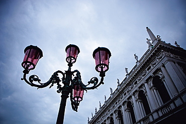 A Light Standard And An Ornate Building With Sculptures Lining The Roof, Venice, Venezia, Italy