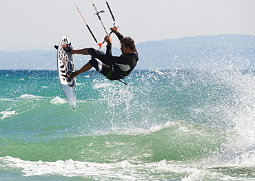 A Man Kitesurfing Off Dos Mares Beach In Front Of Hotel Dos Mares, Tarifa, Cadiz, Andalusia, Spain