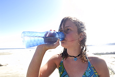 Girl Drinking Clean Water From Refillable Container, On Beach, Vancouver Island, Canada