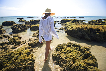 A Woman Tourist Enjoys The Sunshine On The Beach Of A Tropical Island, Koh Lanta, Thailand