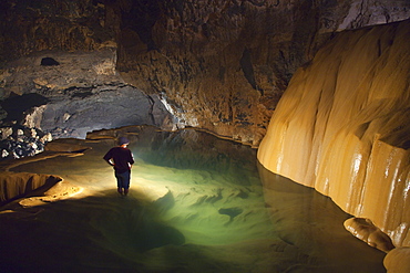 A Filipino Tour Guide Holds A Lantern Inside Sumaging Cave Or Big Cave Near Sagada, Luzon Philippines