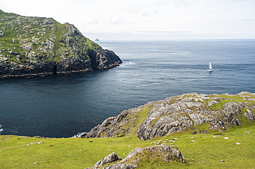 Yacht sailing into dursley sound, Beara peninsula, county kerry, ireland