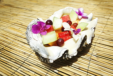 A Fruit Salad With Floral Garnishes Served Inside A Seashell, Hawaii United States Of America