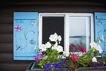 Cabin window with a window flower pot underneath, kenora ontario canada