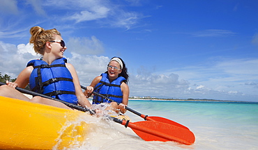 Two Women In Lifejackets Paddling In A Yellow Boat, Punta Cana, La Altagracia, Dominican Republic