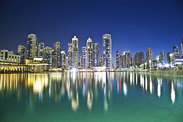 Skyline Of Dubai And The Buildings Reflected In Tranquil Water, Dubai, United Arab Emirates