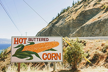 A Sign On The Roadside For Hot Buttered Corn, Peachland, British Columbia, Canada