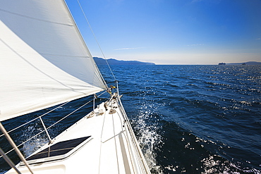 A Sailboat Sails In The Gulf Islands On A Sunny Day, British Columbia, Canada