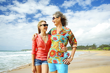 A Mother And Daughter Together On The Beach, Kauai, Hawaii, United States Of America