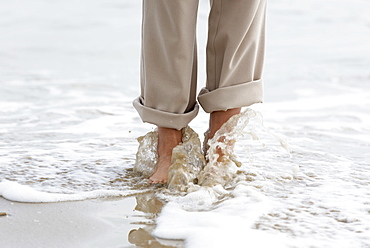 Walking Barefoot Along The Beach With Water Washing Over Feet, Rimini, Emilia-Romagna, Italy