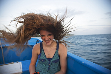 A Girl's Long Hair Whipping Through The Air On A Boat Ride, Utila, Bay Islands, Honduras