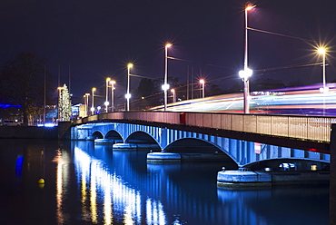 Lights illuminate a bridge over lake zurich at night, Zurich switzerland