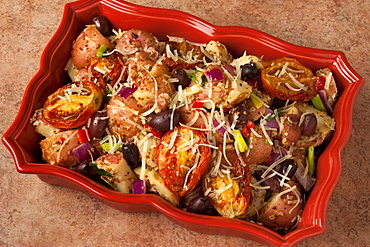 Food - Baked red potatoes with sun-dried tomatoes, Kalamata olives, red onions, red bell pepper, green onions (scallions) and grated Parmesan cheese.