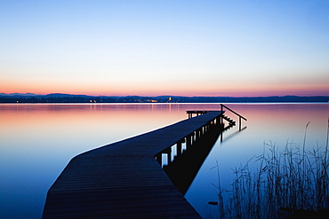 A Wooden Dock Leading Out To A Tranquil Lake At Sunset, Starnberger See, Bavaria, Germany