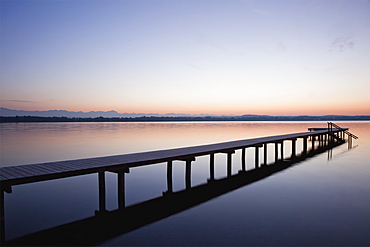 A Wooden Dock Leading Out To A Tranquil Lake At Sunset, Starnberger See, Bavaria, Germany