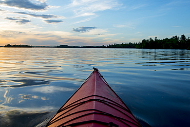 Bow Of A Canoe On A Tranquil Lake At Sunset, Ontario, Canada